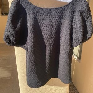 Black top that scoops low in the back